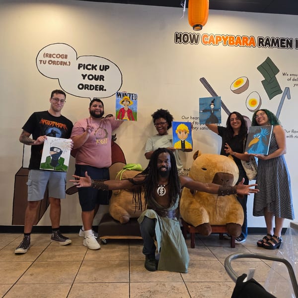Six people proudly display their anime-themed paintings at a Capybara Ramen restaurant.